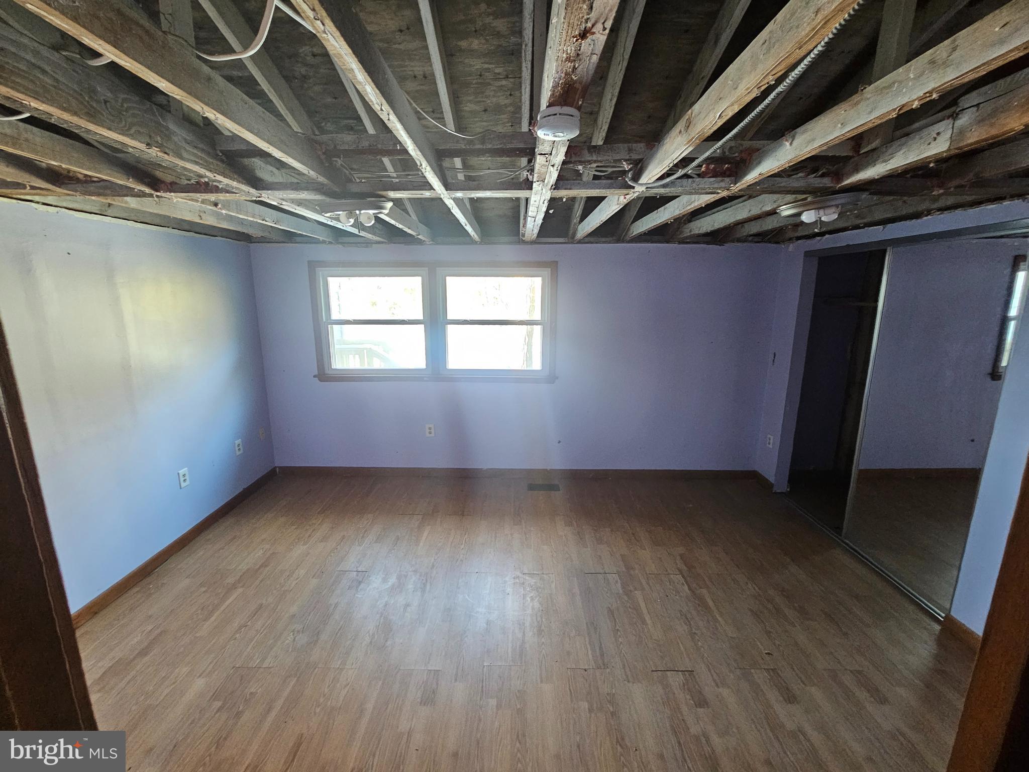 1915 Arundel Road Pasadena, MD 21122 - Photo 9 of 16 a view of an empty room with wooden floor and windows