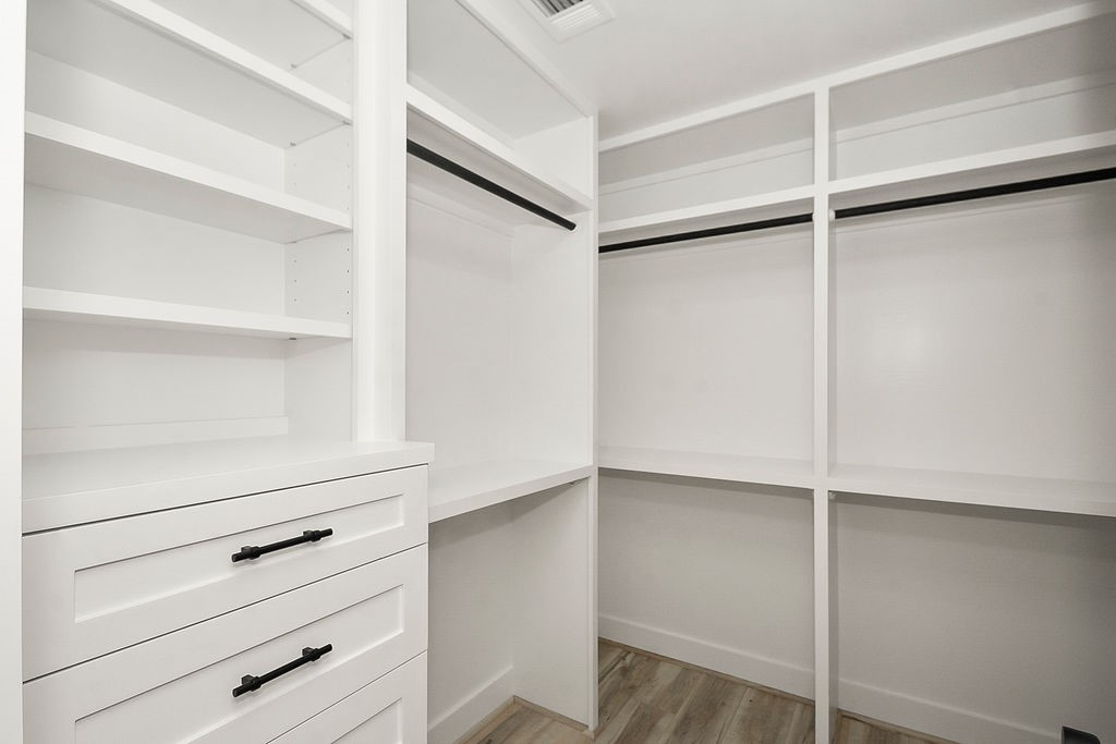 6106 Rutherglenn Drive Houston, TX 77096 - Photo 28 of 41 Another view of the spacious custom closet with built-in storage solutions throughout.
