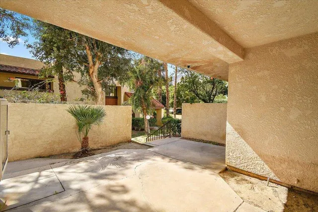 a backyard of a house with table and chairs