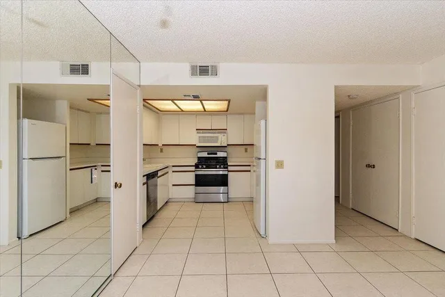 a kitchen with a sink appliances and cabinets