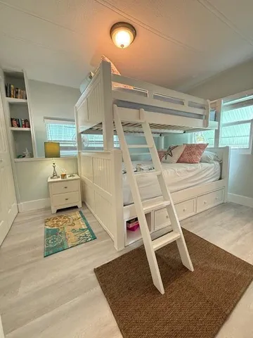 a room with wooden floor and white walls
