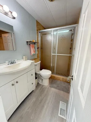 a bathroom with a sink toilet and shower