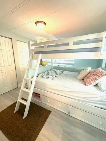 a view of a room with wooden floor and windows