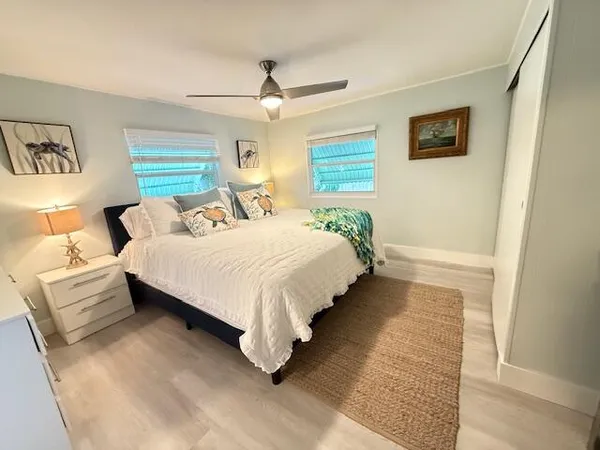 a bedroom with a bed lamp and a window