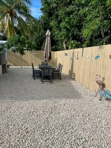 a view of outdoor space with table and chairs