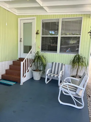 a balcony with furniture and a potted plant