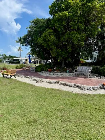 a swimming pool with outdoor seating and yard