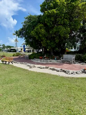 a swimming pool with outdoor seating and yard