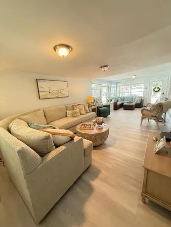 a living room with couches and kitchen view