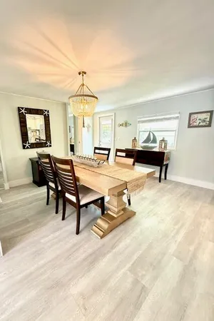 a living room with furniture a window and a chandelier