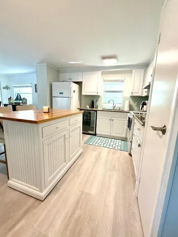 a large white kitchen with a window