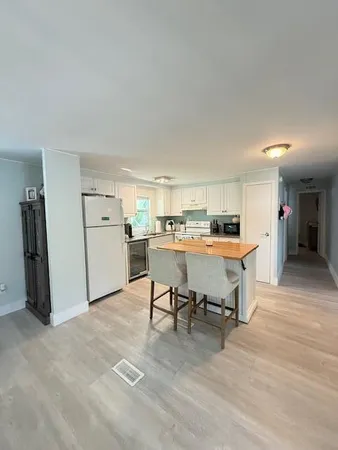 a living room with furniture a counter space and a kitchen