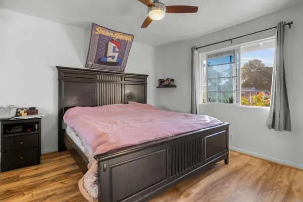 a bedroom with a bed and a mirror