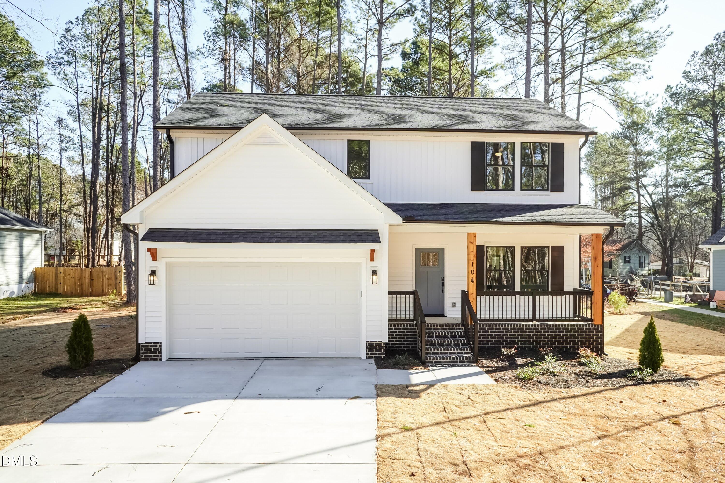 104 Buffalo Drive Spring Hope, NC 27882 - Photo 1 of 48 a view of a white house with large windows next to a road