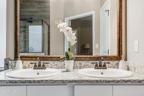 a bathroom with a granite countertop sink and a mirror