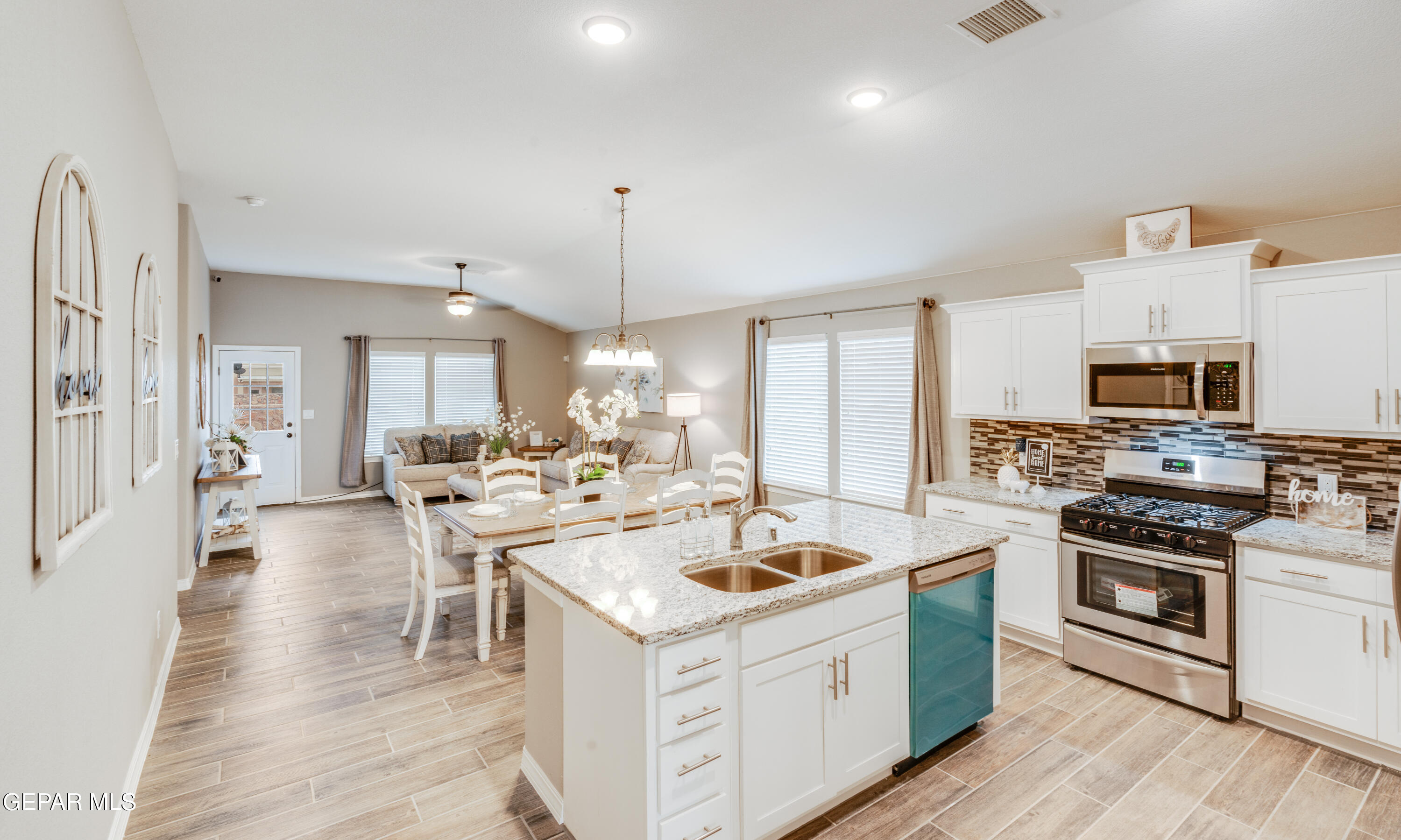 512 Caddo Lane Clint, TX 79836 - Photo 12 of 38 a kitchen with a stove a sink and a refrigerator