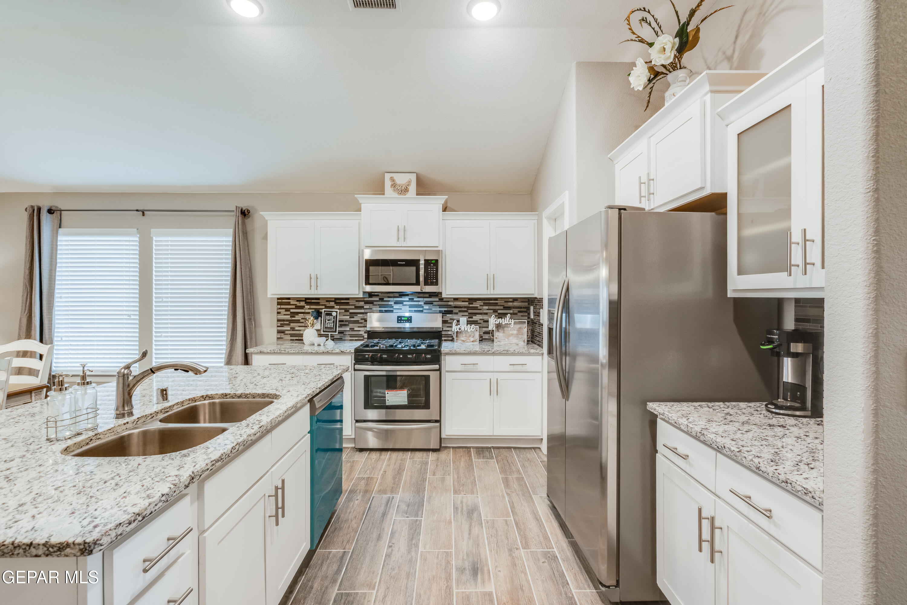 512 Caddo Lane Clint, TX 79836 - Photo 13 of 38 a kitchen with stainless steel appliances granite countertop a sink stove refrigerator and cabinets