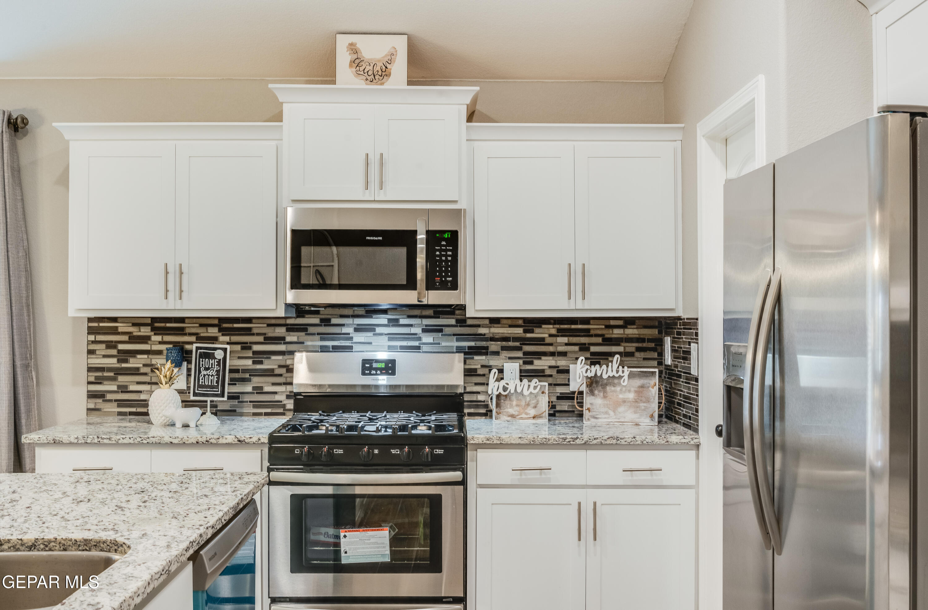 512 Caddo Lane Clint, TX 79836 - Photo 14 of 38 a kitchen with stainless steel appliances granite countertop a stove a refrigerator and a microwave