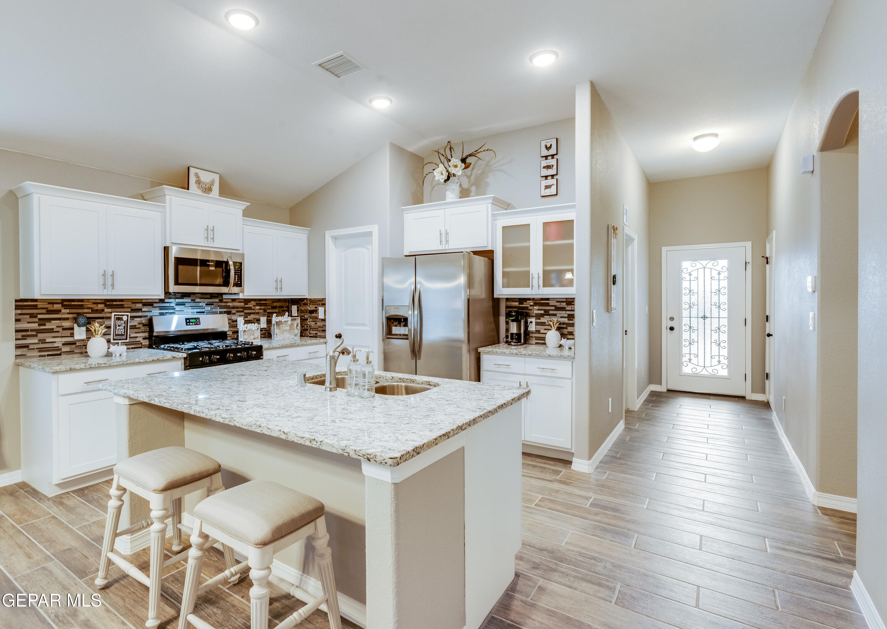 512 Caddo Lane Clint, TX 79836 - Photo 16 of 38 a kitchen with a counter top space a sink appliances and cabinets