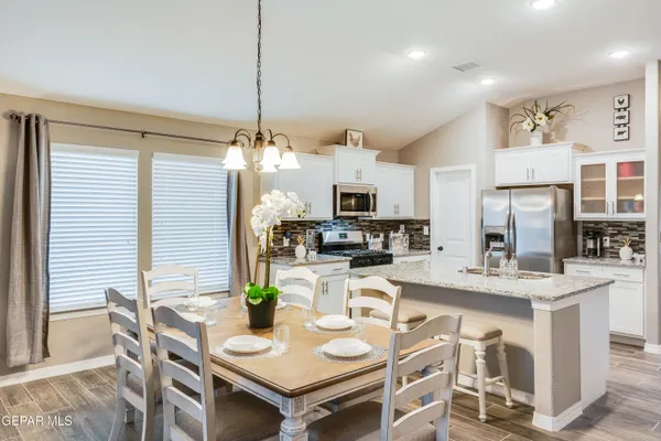a kitchen with kitchen island a large counter top space appliances and living room view