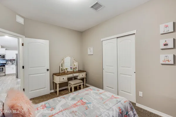 a bedroom with a bed and a chair in it