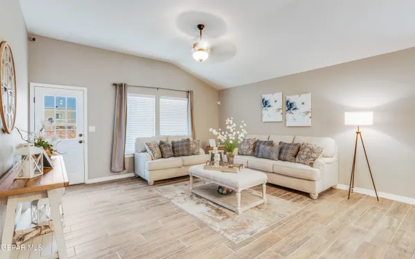 a living room with furniture and a wooden floor