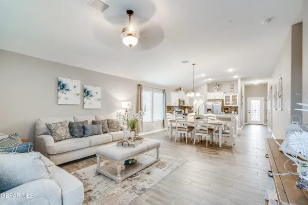 a living room with furniture kitchen view and a dining table