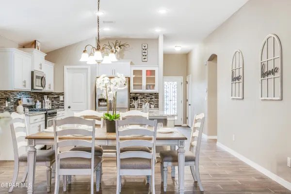 a view of a dining room with furniture and chandelier