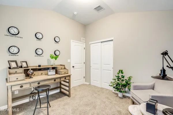 a living room with furniture and flowers