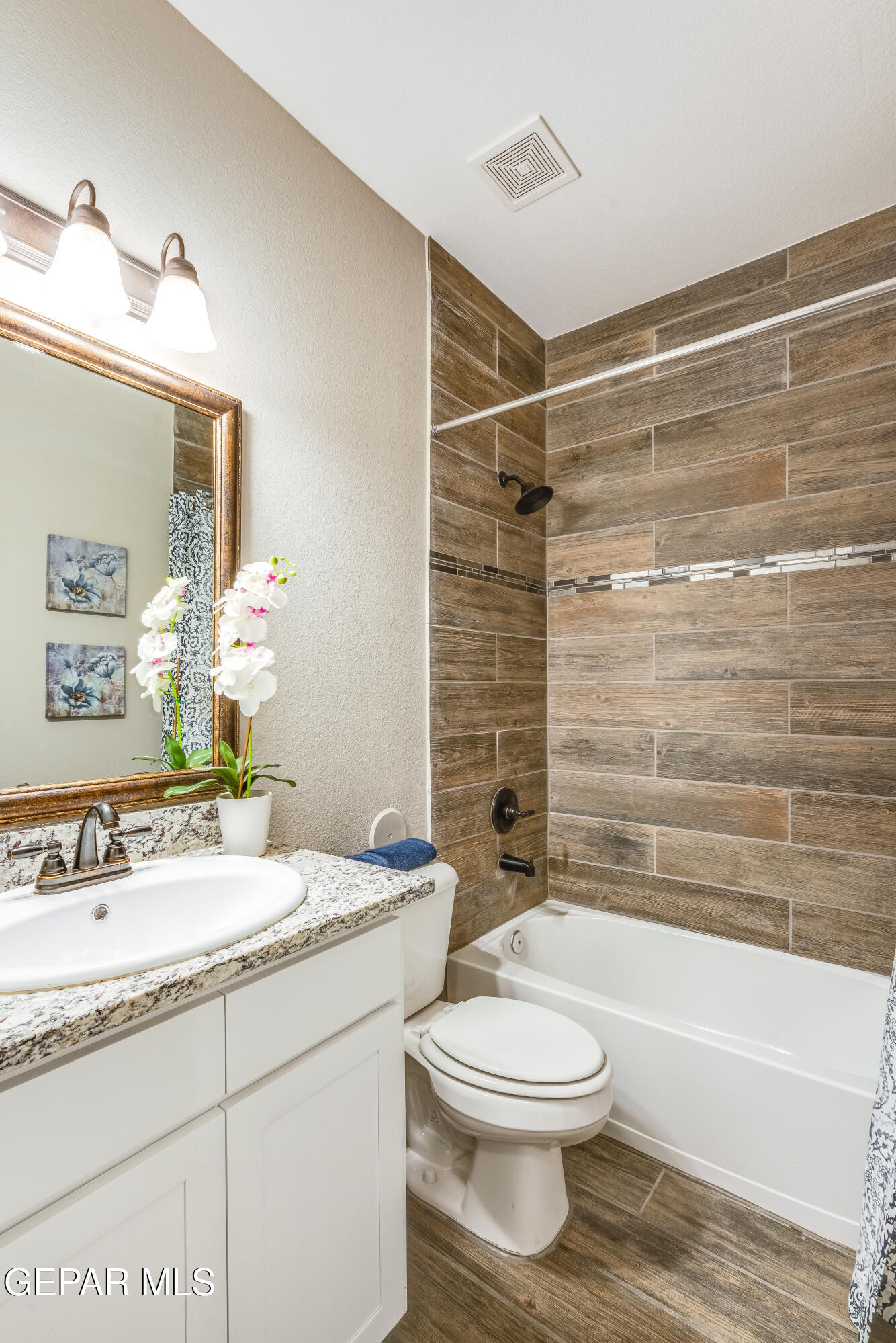 512 Caddo Lane Clint, TX 79836 - Photo 3 of 38 a bathroom with a granite countertop sink toilet a mirror and bathtub