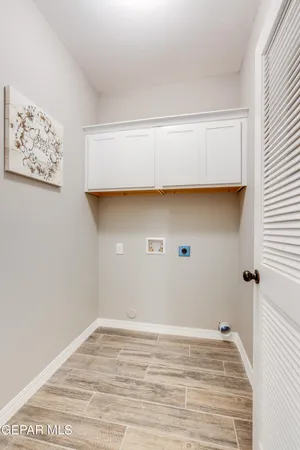 a view of a room with wooden floor and cabinet