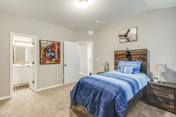 a bedroom with a bed and painting on the wall