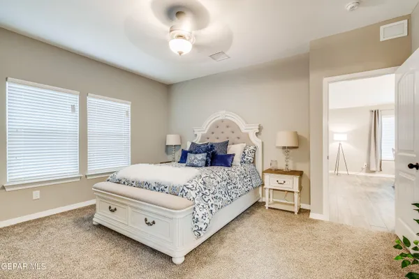 a bedroom with a bed and a chandelier