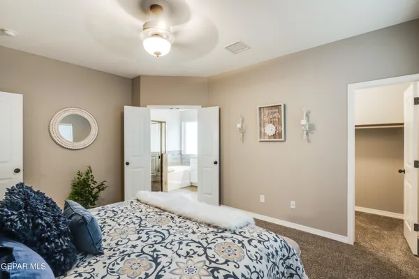 a bedroom with a bed and a chandelier