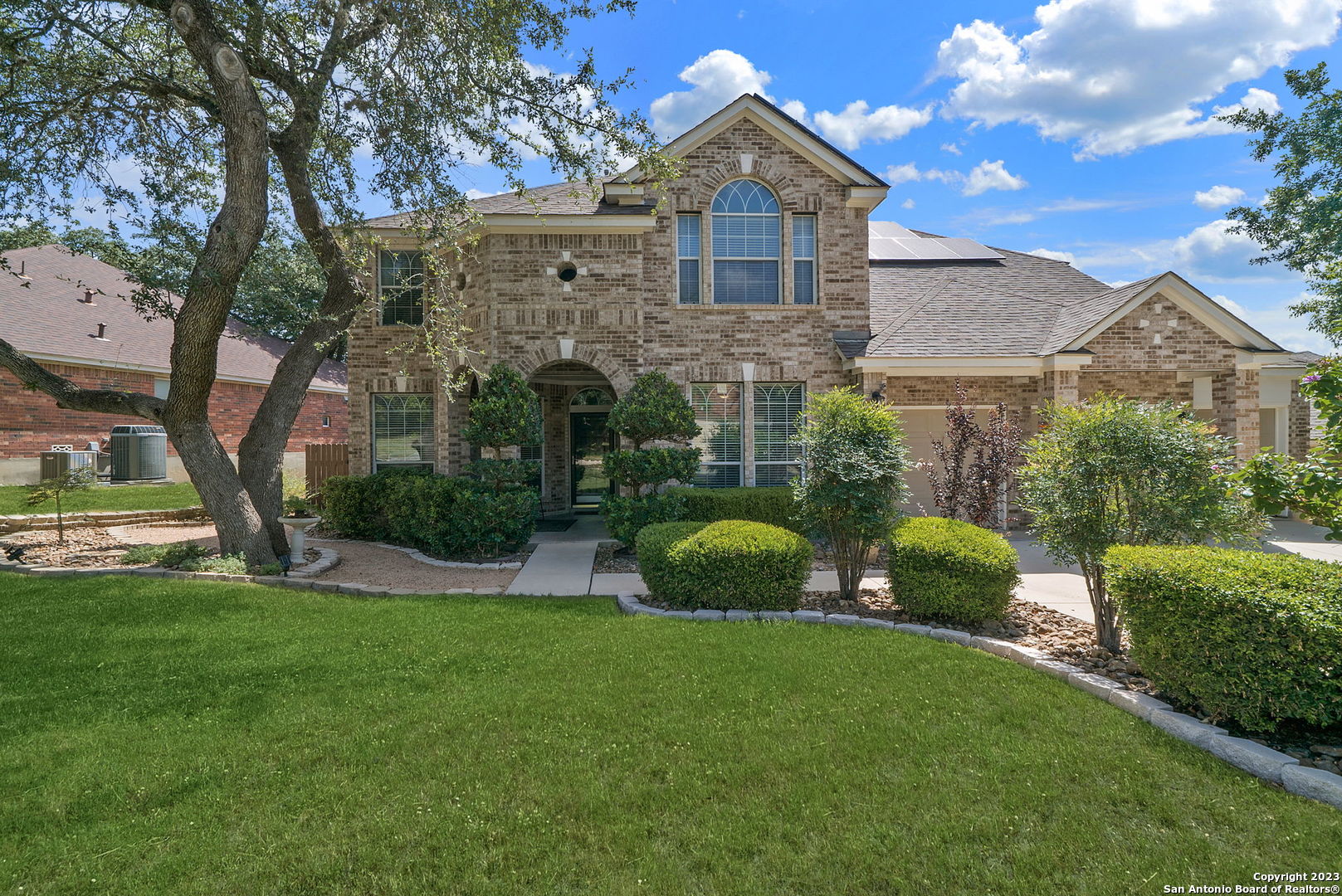 a view of a brick house with a yard