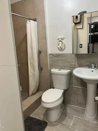 a bathroom with a sink a toilet and a mirror