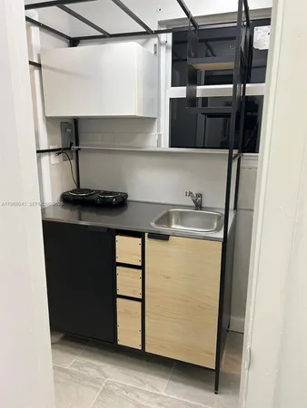 a kitchen with a refrigerator and a stove