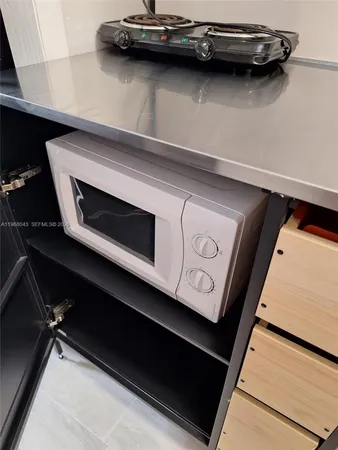 a utility room with sink dryer and window