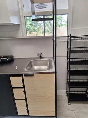a view of a walk in closet with wooden floor