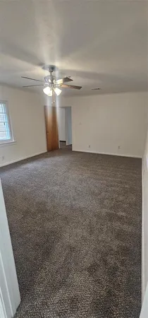 an empty room with a empty space and windows