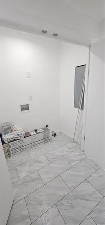 an empty room with wooden floor and white door