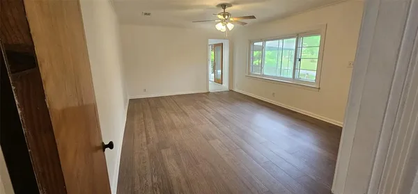 wooden floor in an empty room with a window
