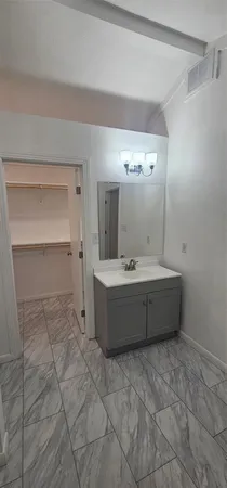 a bathroom with a bathtub sink and mirror