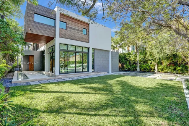 a view of a house with a yard and plants