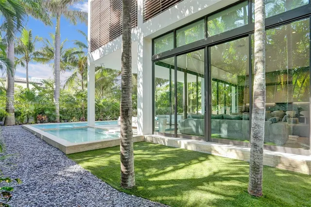 a dinning room with furniture a wooden floor and chandelier