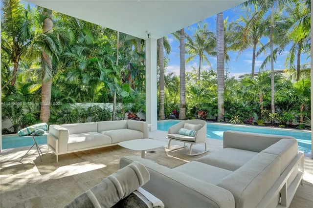 a view of a room with a window and palm tree