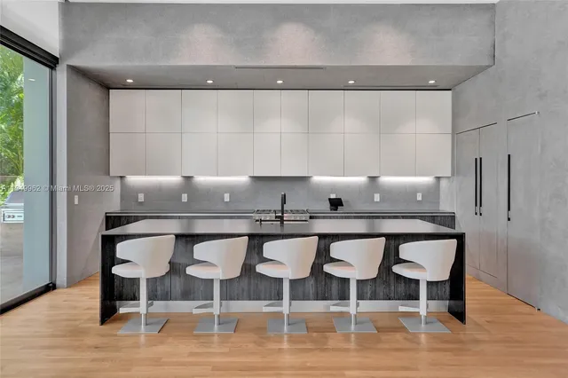 a view of an empty room with wooden floor and closet