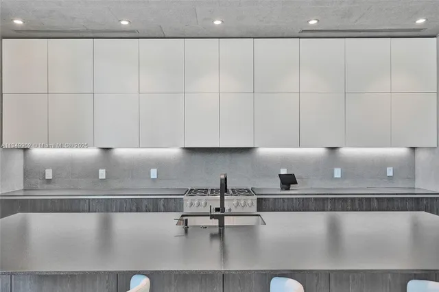 a large white bed sitting in a room next to a window