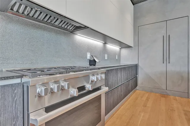 a large bed sitting in a room next to a window