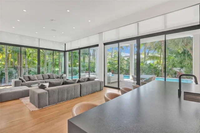a living room with furniture and large windows